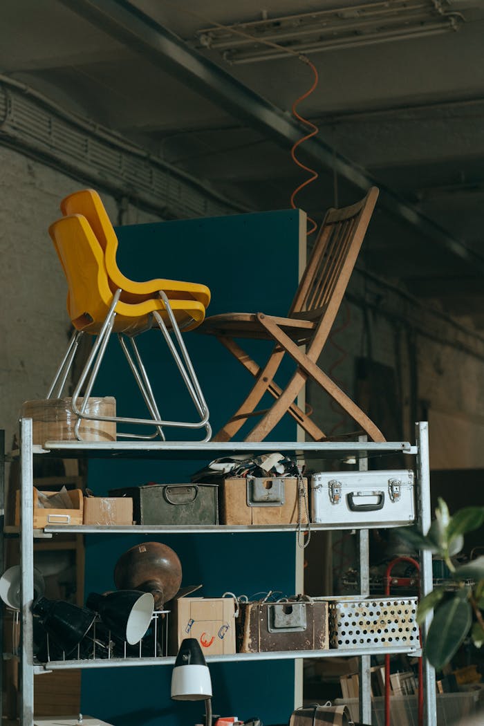 Interior view of a shelf with vintage furniture pieces and storage items.